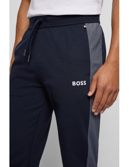 Navy blue sports tracksuit pants with a classic cut from the Boss brand. Detailed view.