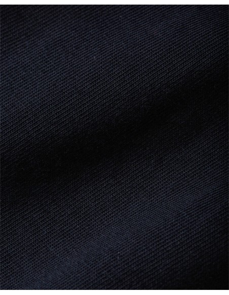 Navy blue short-sleeved t-shirt with embroidered logo of the Tommy Hilfiger brand. Fabric view.